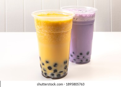 Bubble tea in mango and taro flavors in plastic take out glasses