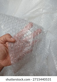 Bubble wrap, a pliable transparent plastic material for protecting fragile items during shipping.