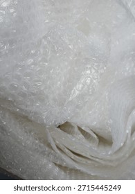 Bubble wrap, a pliable transparent plastic material for protecting fragile items during shipping.