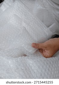 Bubble wrap, a pliable transparent plastic material for protecting fragile items during shipping.