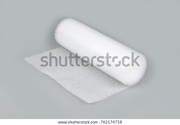Bubble wrap in a roll\
on a gray background