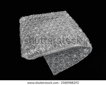 Bubble wrap texture isolated on black background. Packaging