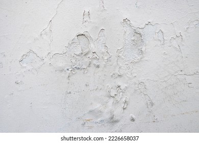 Bubbled paint on a wall. Paint damaged by water. Poorly isolated wall with bubbling paint.