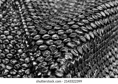 bubbled plastic. the surface of the dampening plastic wrap is black. plastic with air balls on the surface used for packing glassware or electronics or sensitive items. selective focus