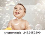 Bubbles, baby and happy in bathroom for bath, cleaning and hygiene with night time routine for growth or development. Toddler, home and washing in bathtub for skin care, cute and playful in house