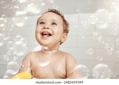 Bubbles, baby and happy in bathroom for bath, cleaning and hygiene with night time routine for growth or development. Toddler, home and washing in bathtub for skin care, cute and playful in house - Powered by Shutterstock