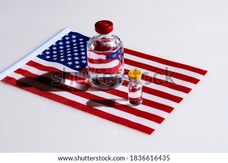 bubbles with clear liquid on the background of the American flag. The concept of a vaccine to protect against coronavirus infection.