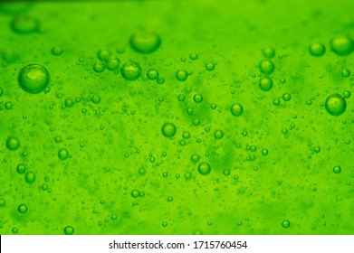 Bubbles in macro view of a green-colored bath gel