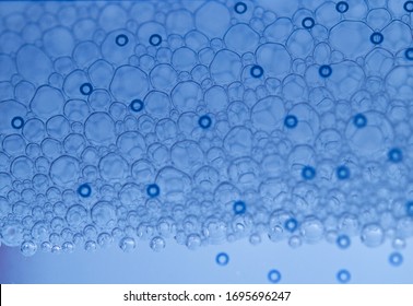 Bubbles in macro view of a micellar water through a blue filter