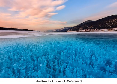 Bubbles of methane gas frozen into clear ice lake baikal, russia - Powered by Shutterstock