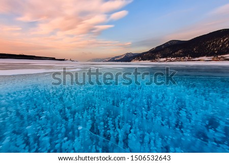Bubbles of methane gas frozen into clear ice lake baikal, russia