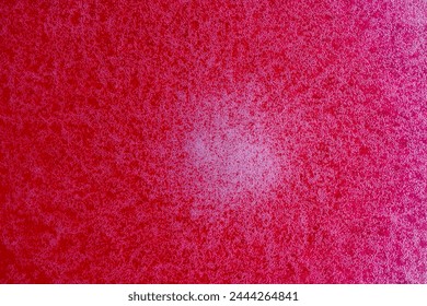 Bubbles on the surface of the drink of red raspberries soda drink on background. Fresh drink of scarlet cranberry or cherry or red currant or viburnum, close up, top view
