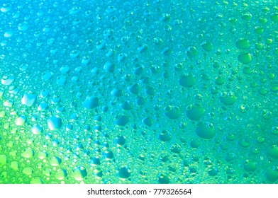 Bubbles on water surface with a gradient from green to blue