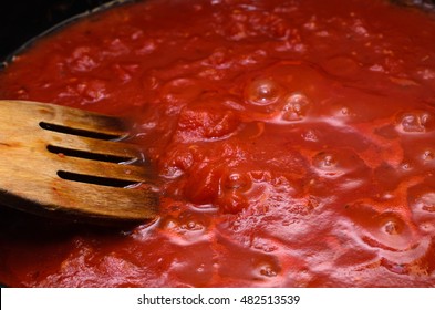 Bubbling Hot Tomato Sauce For Pasta, Cooking In Pan With Wooden Spatula.