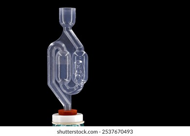 bubbling plastic fermentation tube on the wine balloon isolated on black background with copy space, equipment for homemade wine or alcoholic fermentation - Powered by Shutterstock