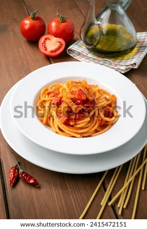 Bucatini all'amatriciana, a typical recipe of italian pasta with guanciale, tomatoes and pecorino, european food 