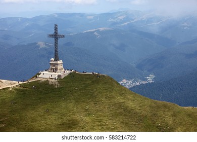 Bucegi Mountains, ROMANIA - AUGUST 14, 2016: Heroes' Cross on Caraiman Peak. The Heroes' Cross is a monument built between 1926 and 1928 on Caraiman Peak at an altitude of 2,291 m. 