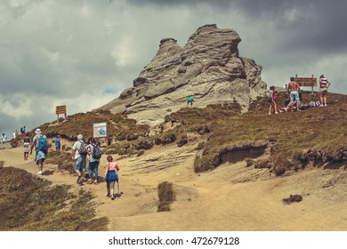 Bucegi Mountains, Romania - August 6, 2016: Hundreds of people hike the trails to the Sphinx, the mythical megalith with human face resemblance located at 2,216 m altitude in Bucegi Mountains.