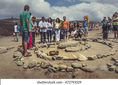 Bucegi Mountains, Romania - August 6, 2016: People attend a spiritual ritual organized around a spiral of stones near the Sphinx, the sacred megalith located at 2,216 m altitude in Bucegi Mountains.