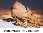 Bucegi, Romania. Beautiful sunset with Sphinx, natural rock formation in Carpathian Mountains,  famous landmark of Romania.