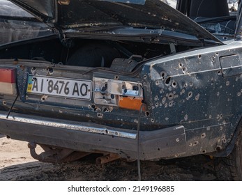 Bucha, Ukraine - April 2022: Cars Of Civilians Shot By The Russian Army. Car After Being Shot With Machine Guns. Car After Shelling From A Machine Gun And Cut By Fragments From Mines.