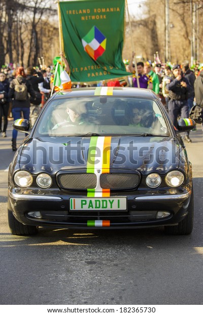BUCHAREST - MARCH 16: Jaguar car\
leads the 2nd edition St. Patrick\'s Day Parade on Calea Victoriei\
(Victory Avenue) on March 16, 2014 in Bucharest,\
Romania.