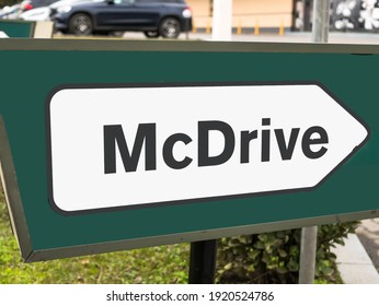 Bucharest, Romania - 02.10.2021: Mcdrive Arrow Sign Pointing To A McDonald's Restaurant And Fast Food.