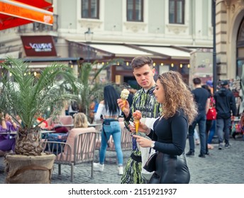 Bucharest, Romania - 04.08.2022: Busy Weekend Day With Many People On The Streets Of Old Town Center In Bucharest. Couple Eating Ice Cream