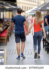 Bucharest, Romania - 09 12 2019: Young Couple Walking Among Restaurant Terraces In The Old Center