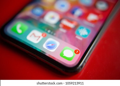 BUCHAREST, ROMANIA - APRIL 1, 2018: Closeup Photo Of An Iphone X Home Screen With Imessage Icon On A Red Background