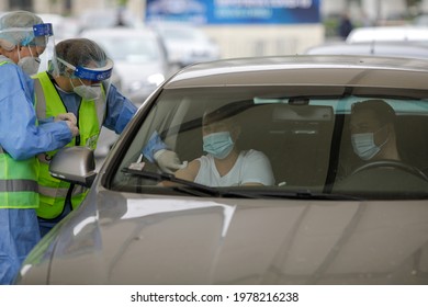 Bucharest, Romania - April 29, 2021: A Woman Is Getting Covid-19 Vaccine In His Arm In His Car, In A Drive Thru Vaccination Centre In Bucharest, Romania.