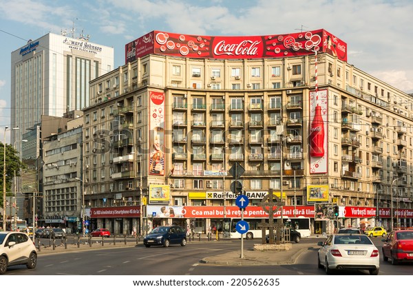 BUCHAREST,\
ROMANIA - AUGUST 06, 2014: The Roman Square (Piata Romana) is a\
major traffic intersection in downtown Sector 1 and the main\
building is the Academy of Economic\
Studies.
