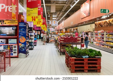 BUCHAREST, ROMANIA - AUGUST 10, 2014: People Shopping For Bread Products In Supermarket Store Aisle.