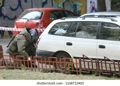 BUCHAREST, ROMANIA - August 31, 2018: Bomb Disposal Expert in Bomb suit for Explosive ordnance disposal (EOD) is verifying a suspect car on a street in Bucharest, on August 31.