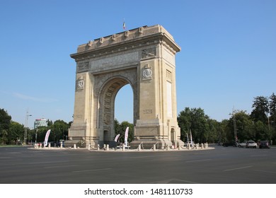 Bucharest, Romania - August 8, 2019: Triumphal Arch with flag, landmark architecture in the northern part of Bucharest, on the Kiseleff Road.