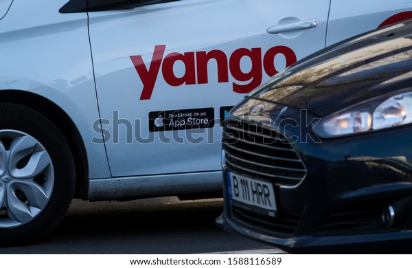 Bucharest, Romania - December 09, 2019: A car\
with the Yango logo of the multinational Yandex.Taxi BV belonging\
to Russian multinational corporation Yandex N.V. is seen on a\
street in Bucharest.