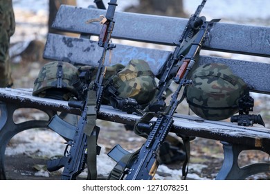 Bucharest, Romania - December 1, 2018: Polish Beryl 5.56×45mm NATO Assault Rifles With Holographic Sights, Vertical Foregrips And Bayonets Lay On The Ground With Other Army Objects