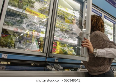 Bucharest, Romania, December 20, 2012: A Woman Chooses Frozen Vegetables In A Supermarket In Bucharest.