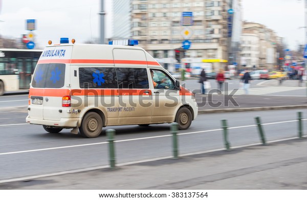 Bucharest,\
Romania - February 05, 2016: First aid ambulance car driving very\
fast on city street due to an emergency\
call.