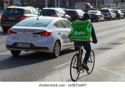 Bucharest, Romania - January 07, 2020: An Uber Eats food delivery courier delivers food in Bucharest, Romania.