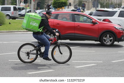 Bucharest, Romania - June 10, 2018: An Uber Eats courier delivers food in Bucharest, Romania.