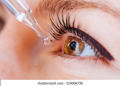 Bucharest, Romania - June 18,2016 : Closeup of a eyedroper prepared to release medical liquid into a brown eye 