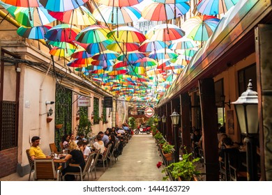 Bucharest / Romania - june 20 2019: Cafe with colorful umbrellas on a street in Bucharest