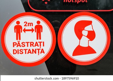 Bucharest, Romania - June 6, 2020: Mandatory 2 meters social distancing and medical protection mask at the entry into a store, to mitigate the spread of the Coronavirus (COVID-19) outbreak