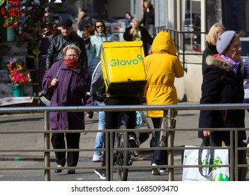 Bucharest, Romania - March 11, 2020: A Glovo food delivery courier delivers food in Bucharest, Romania. - Shutterstock ID 1685093470