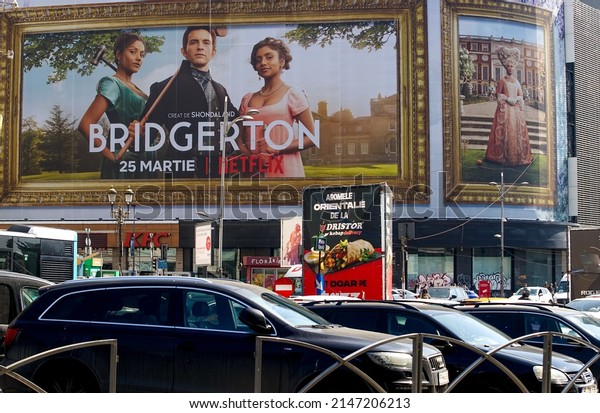 Bucharest, Romania - March 24, 2022: Extra\
large banner advertising Bridgerton TV Series is displayed on the\
Unirea Shopping Center, in downtown\
Bucharest.