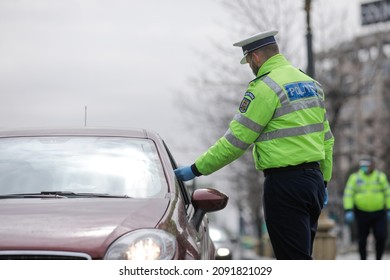 Bucharest, Romania - March 25, 2020: Romanian Road Police Officer Pulls Over A Car To Check For The Driver’s Identity Papers.