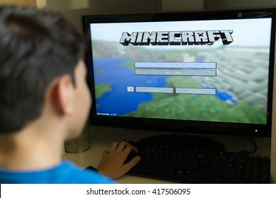 Bucharest, Romania - May 02, 2016: Boy playing Minecraft on PC. Minecraft is a very popular game for all devices.
