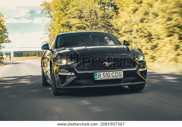 Bucharest, Romania - May 20 2021: Ford Mustang\
Ecoboost black coupe with spoiler front view, grille, headlights\
and wheel details