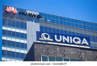 Bucharest, Romania - May 20, 2022: A Logo Of Huawei, Chinese Telecommunications Equipment Company And UNIQA Insurance Group AG, Are Displayed At The Top Of Their Headquarters In Bucharest, Romania.